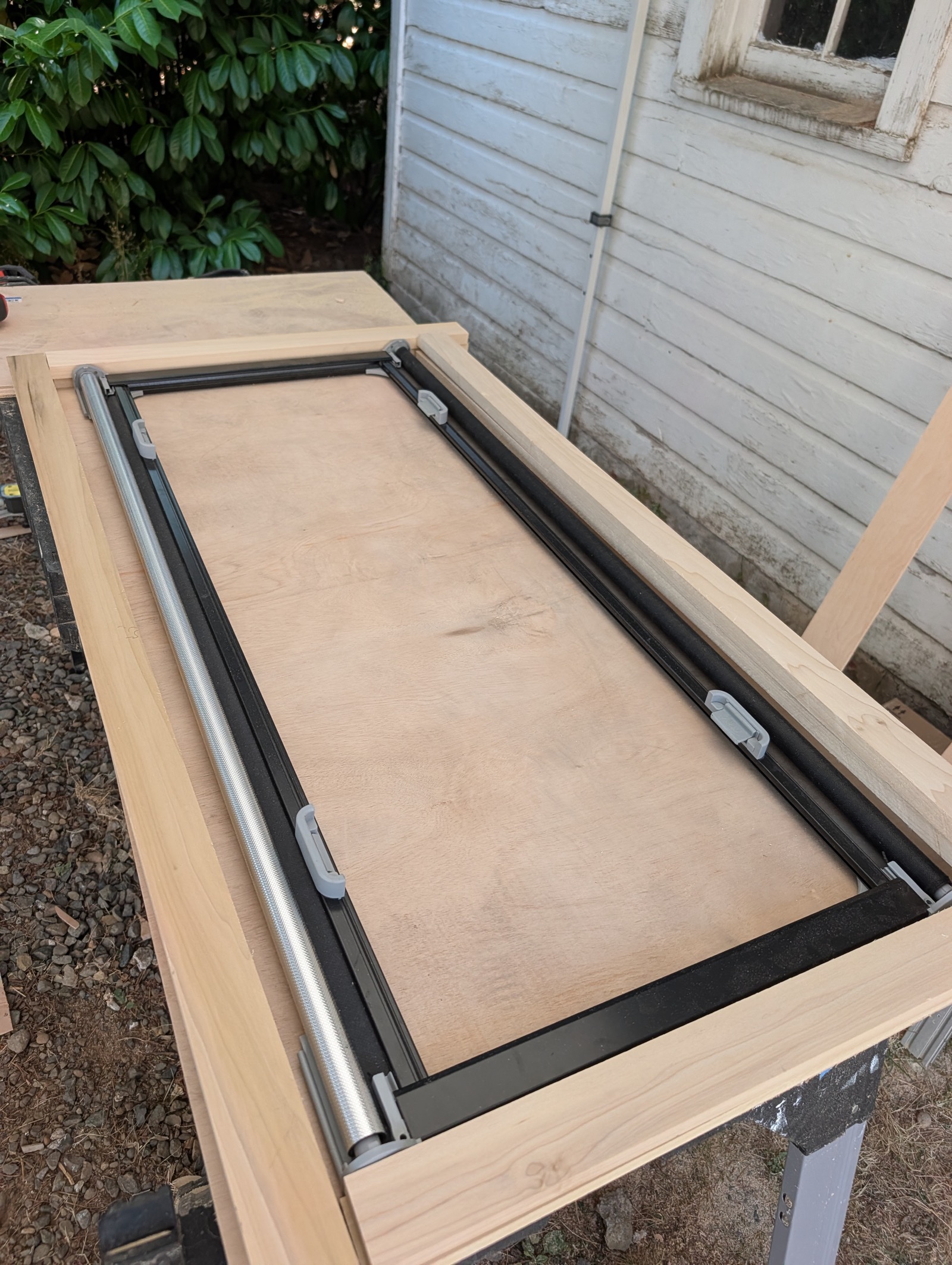 Poplar rails dry-fit around the blind cassette on the bench